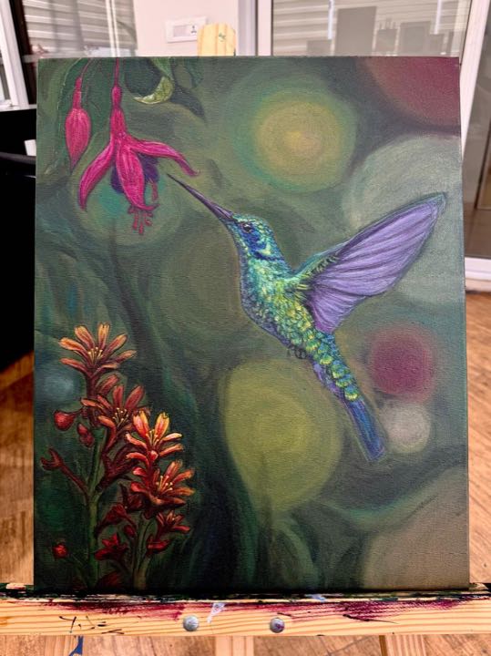 Hummingbird painting on a wooden easel in the studio