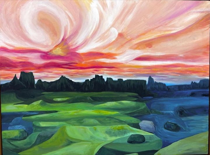 Pink and orange sunset sky over dark rock spires